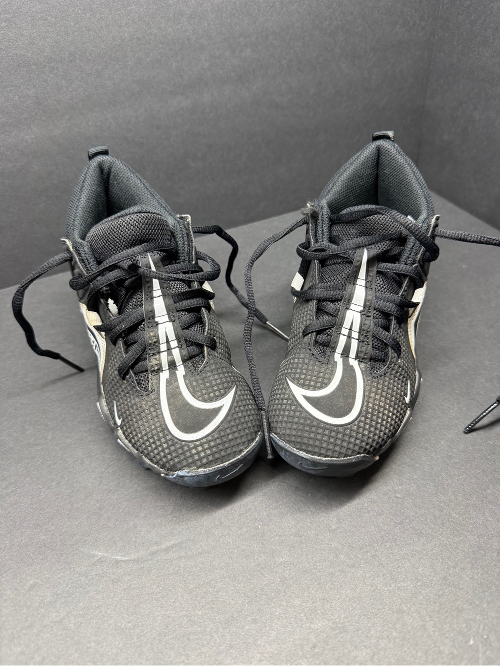 Nike Black Kids Sneakers cleats with White Swoosh Accents